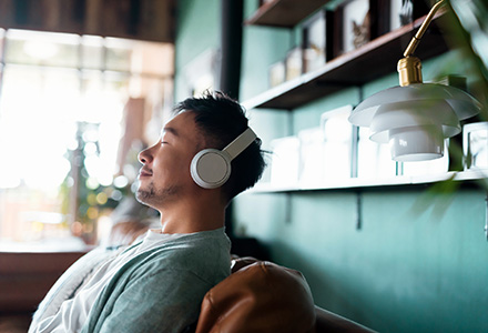 Man with headphones in deep thought in office