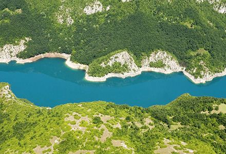 Aerial view of a river flowing between mountainous areas