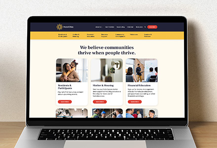 Laptop open to Model Cities' home page