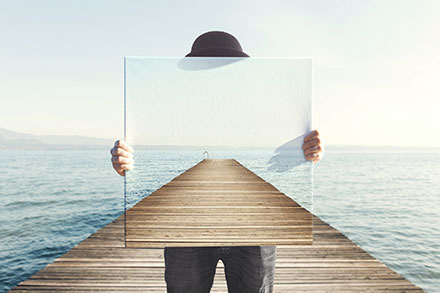 Illustration of a person holding up a poster showing a dock that is behind them giving the illusion they are not there