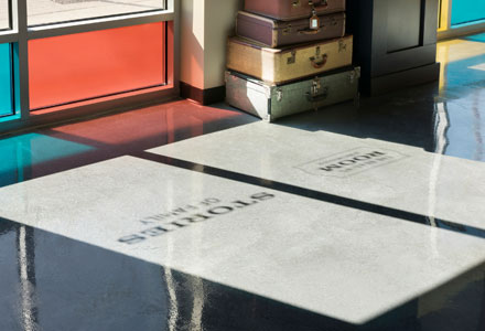 Image of shadows reflected from windows in the Reading Room. Window decals read: "The Reading Room at BROWNstone" and "Stories of Family"