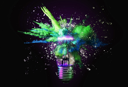 Photo of a lightbulb exploding with colorful smoke