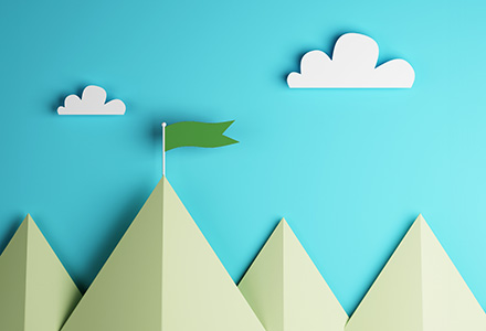 Illustration with cut paper of a series of mountains with a flag at the top of one of them