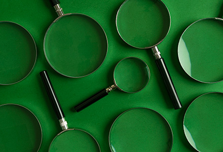 Series of magnifying glasses on a green background