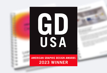 Blurred photo of MillerKnoll Design Days Learning guide with seal for GDUSA American Graphic Design Awards 2023 Winner on top