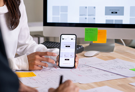 UX UI designer testing a prototype on a phone