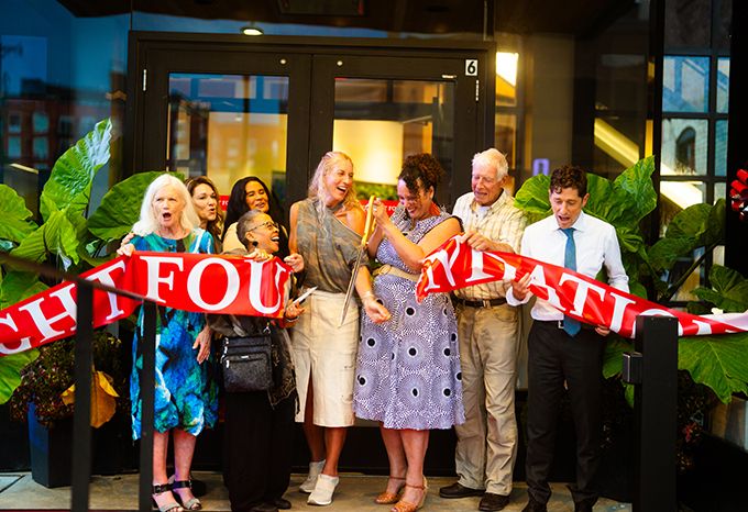 Ribbon cutting at McKnight Foundation's new office building with Peg Birk, Phyllis Goff, Perry Moriearty, Shelly Buck, Erika Binger, Tonya Allen, James (Mac) Binger, and Jacob Frey. Photo by Raww Files Media.