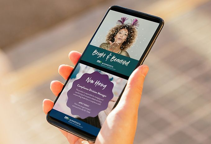 Person holding a phone looking at social media posts about New Year's and a job posting