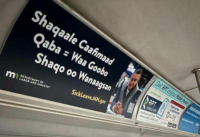 Bus board in Somali for the Minnesota Department of Labor Earned Sick and Safe Time Campaign