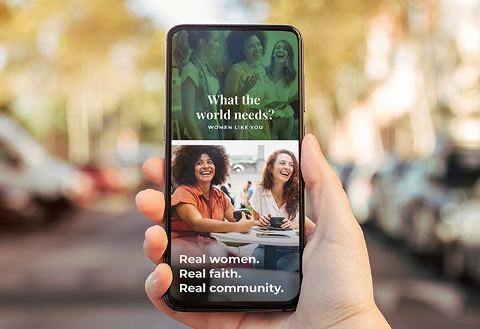 Person holding phone with social media graphics with the headline: What world needs? Women like you.